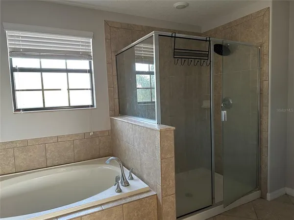 a bathroom with a bathtub and shower