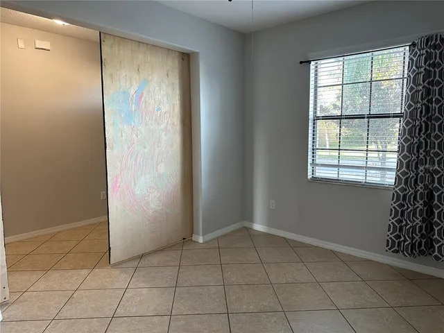 an empty room with windows and closet