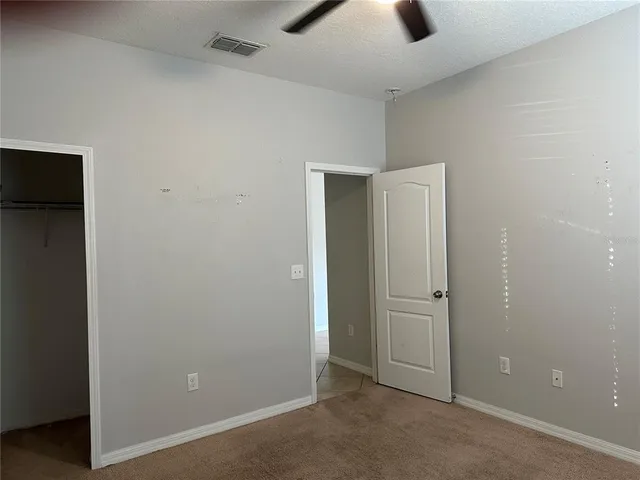 an empty room with ceiling fan