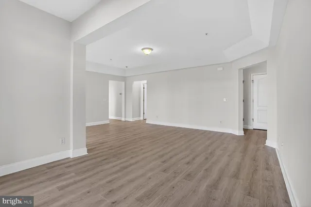 a view of a room with wooden floor