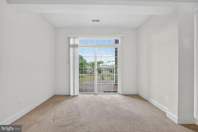 a dining room with furniture a chandelier and wooden floor