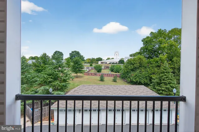 a spacious bedroom with a large bed couch and a window