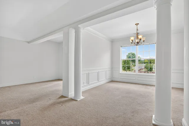 a view of an empty room with a ceiling fan
