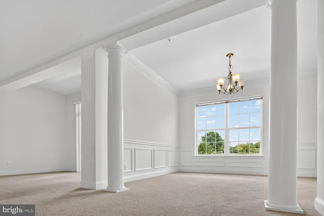 a view of an empty room with a ceiling fan