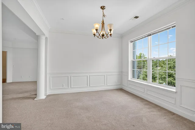 an empty room with a ceiling fan and a window