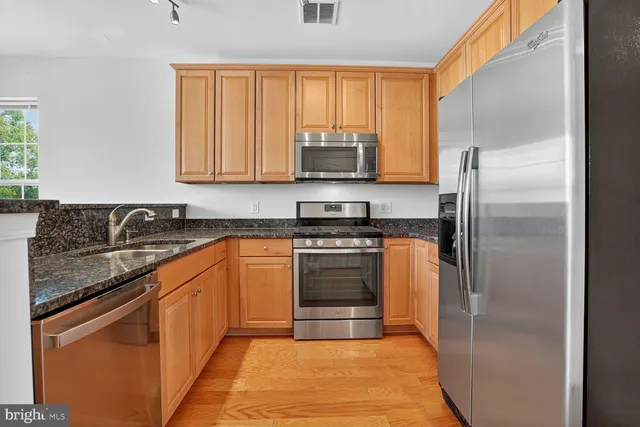 a living room with furniture a chandelier and a large window