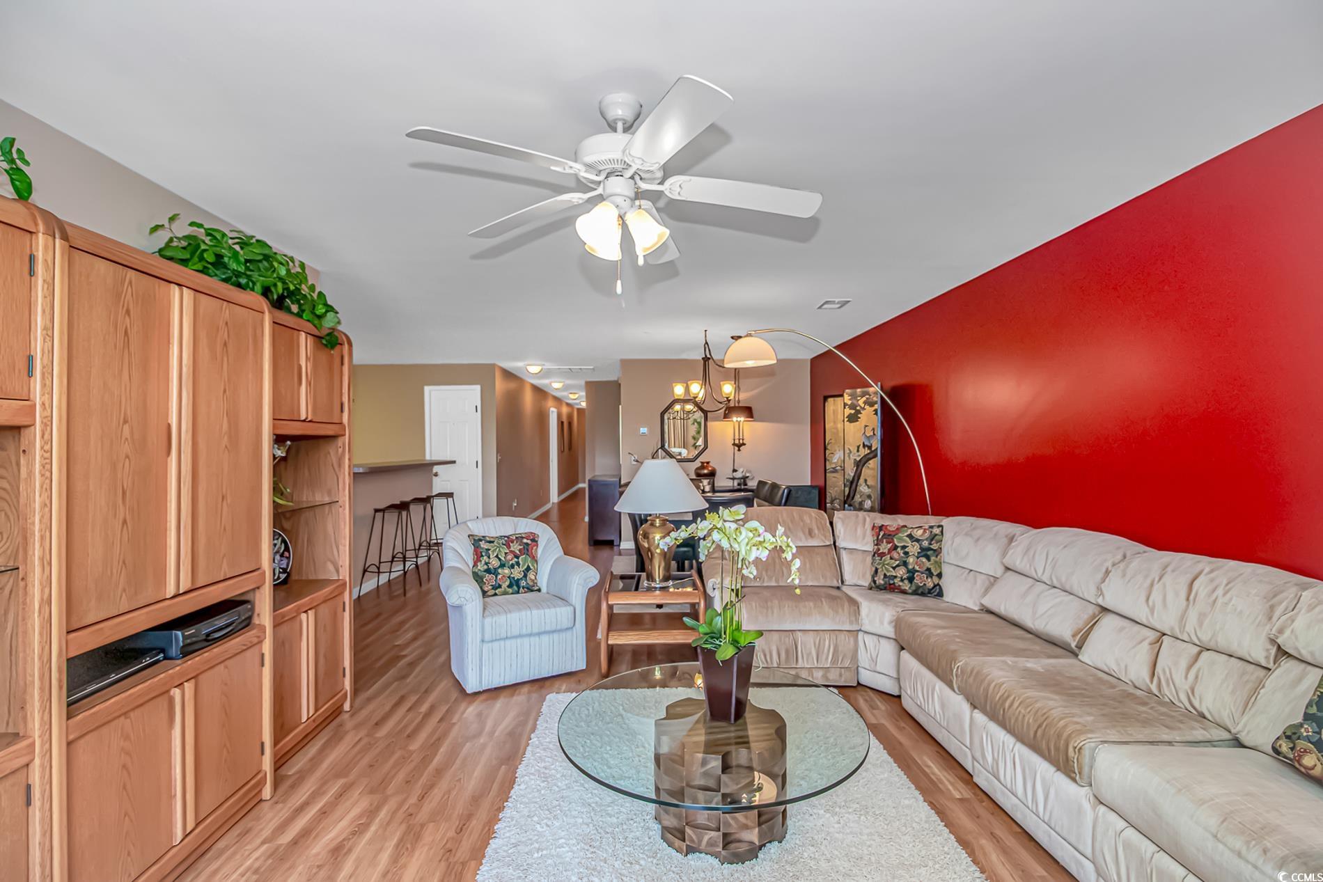 4366 Rivergate Lane, Unit 306 Little River, SC 29566 - Photo 11 of 32 Living area featuring ceiling fan, light wood-type flooring, and a chandelier