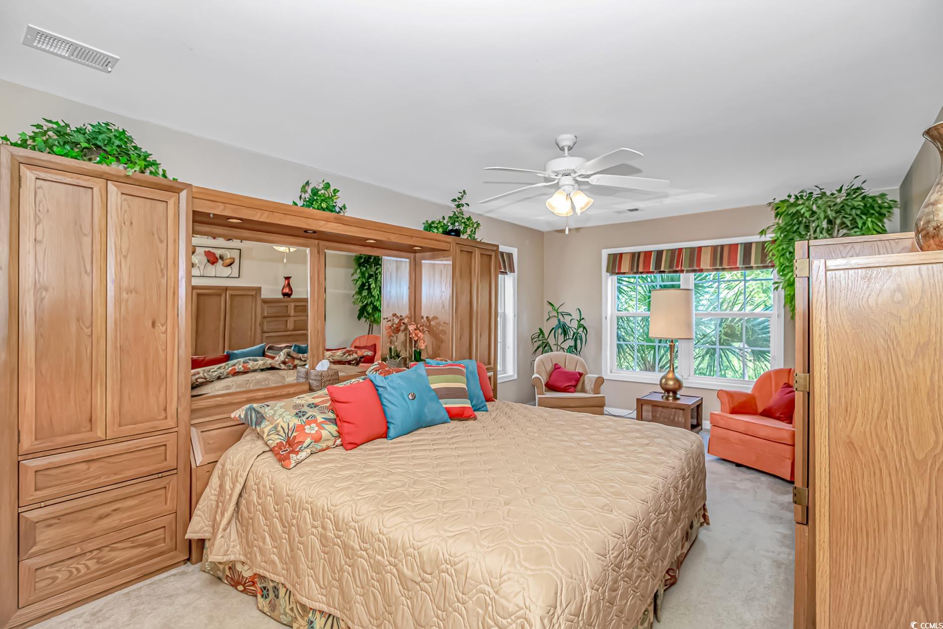 4366 Rivergate Lane, Unit 306 Little River, SC 29566 - Photo 12 of 32 Bedroom with light colored carpet and a ceiling fan