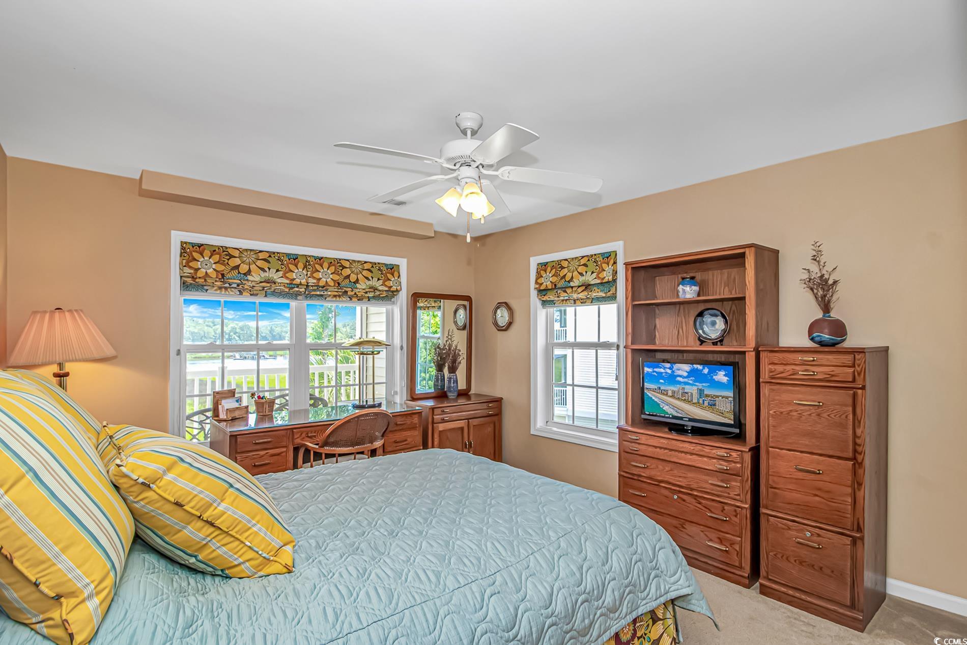 4366 Rivergate Lane, Unit 306 Little River, SC 29566 - Photo 16 of 32 Bedroom with multiple windows, light colored carpet, and a ceiling fan