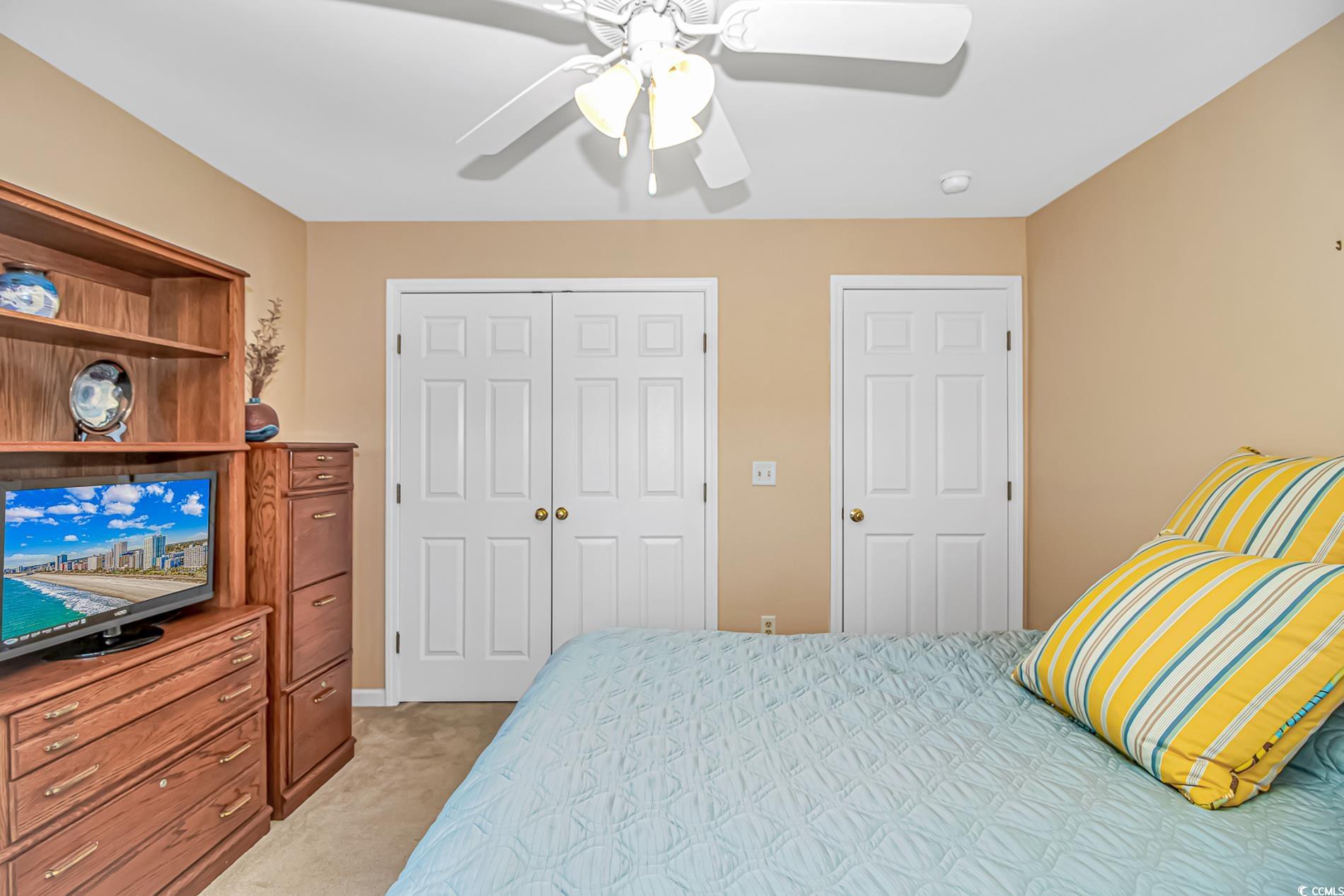 4366 Rivergate Lane, Unit 306 Little River, SC 29566 - Photo 17 of 32 Bedroom with a closet, light colored carpet, and a ceiling fan