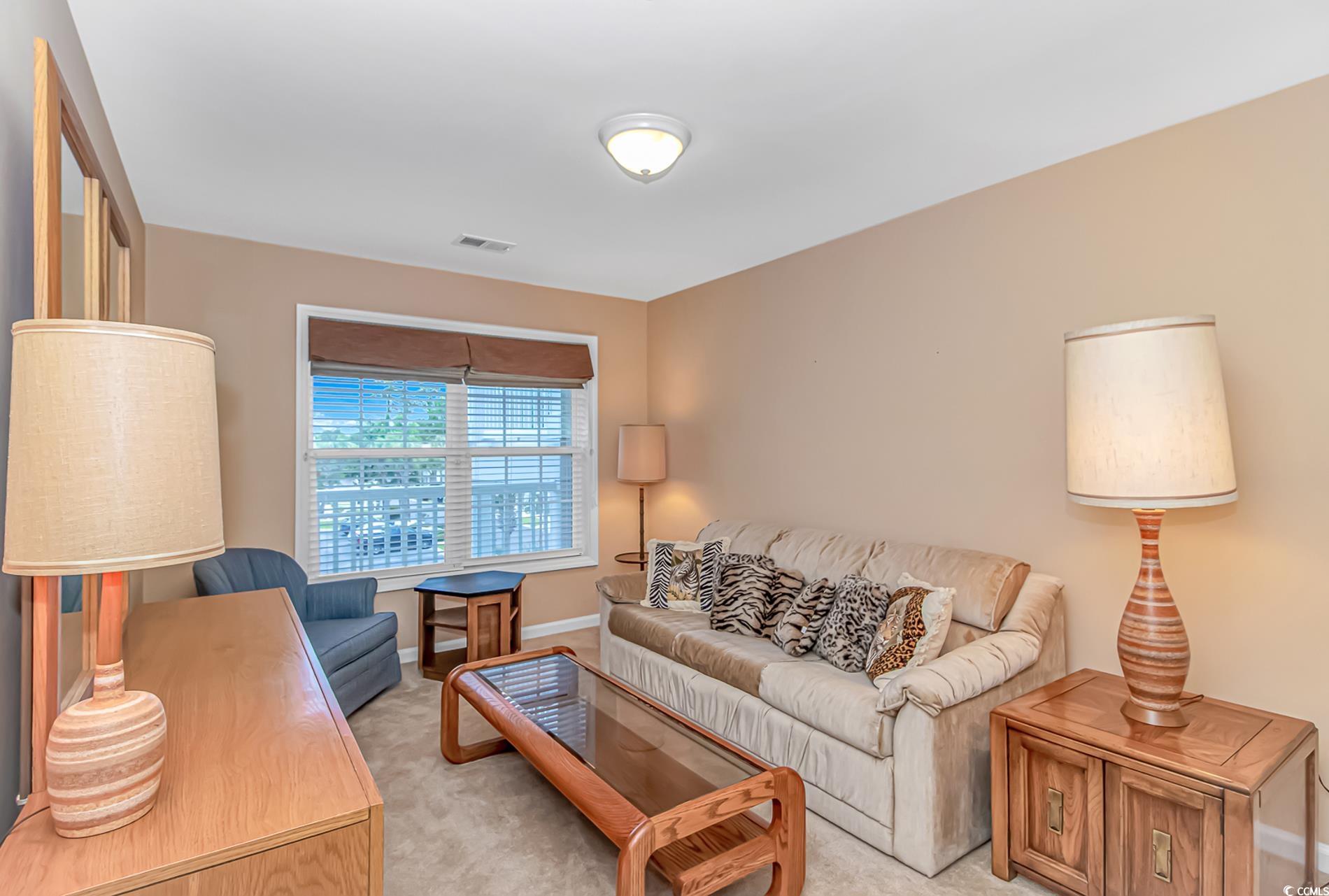 4366 Rivergate Lane, Unit 306 Little River, SC 29566 - Photo 18 of 32 Living area with light carpet and baseboards