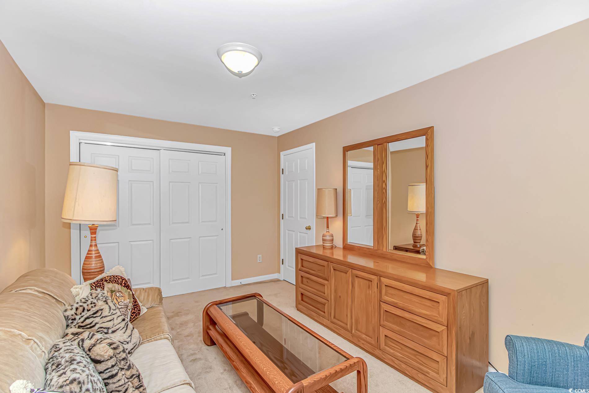 4366 Rivergate Lane, Unit 306 Little River, SC 29566 - Photo 19 of 32 Living area with light colored carpet and baseboards
