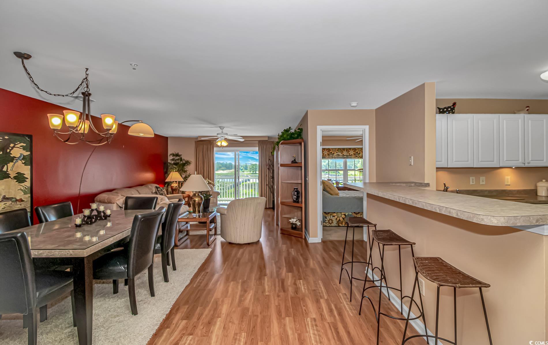 4366 Rivergate Lane, Unit 306 Little River, SC 29566 - Photo 2 of 32 Dining space with light wood finished floors and a chandelier