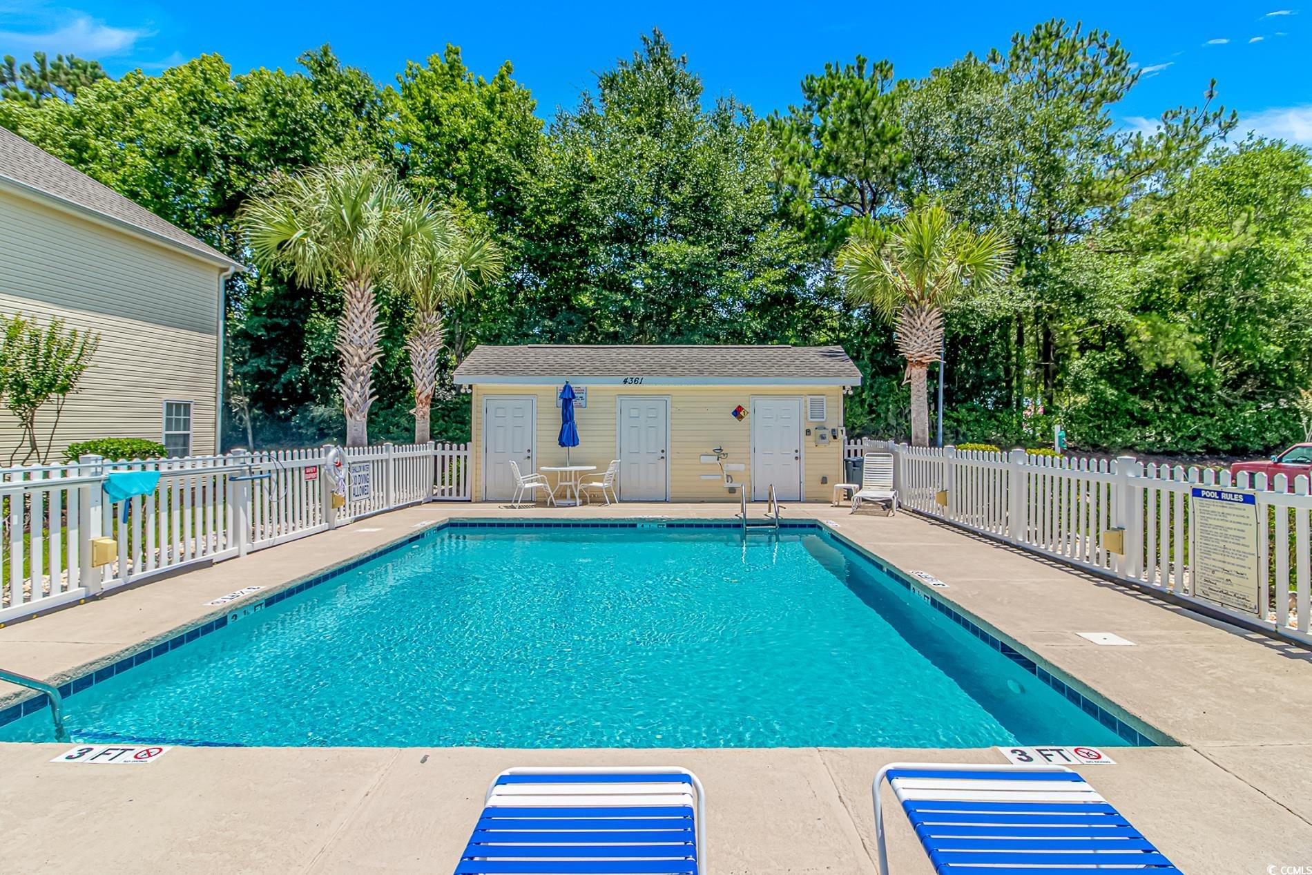4366 Rivergate Lane, Unit 306 Little River, SC 29566 - Photo 23 of 32 Community pool featuring a patio area and view of scattered trees