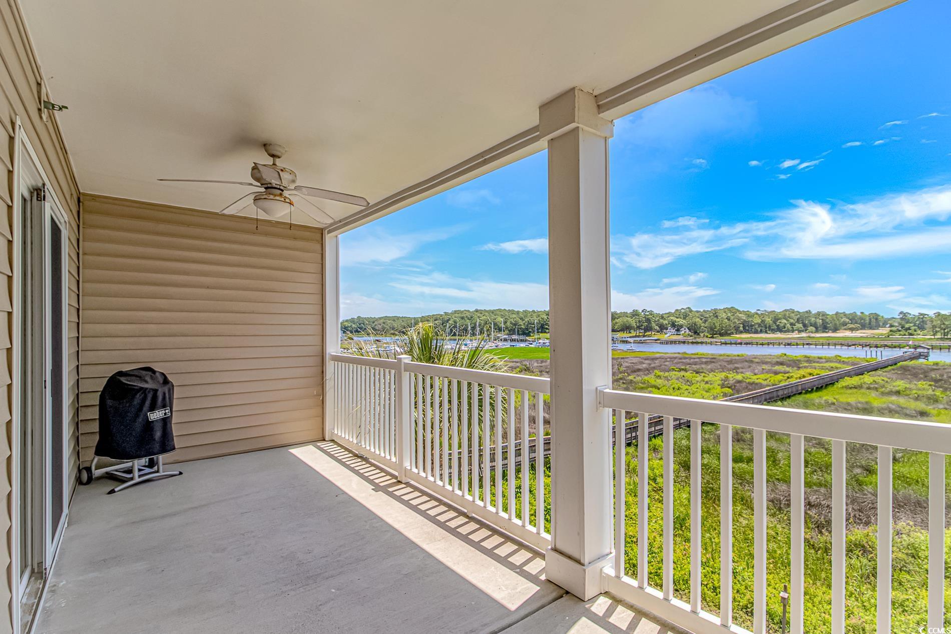 4366 Rivergate Lane, Unit 306 Little River, SC 29566 - Photo 25 of 32 Balcony with a ceiling fan, a water view, and grilling area
