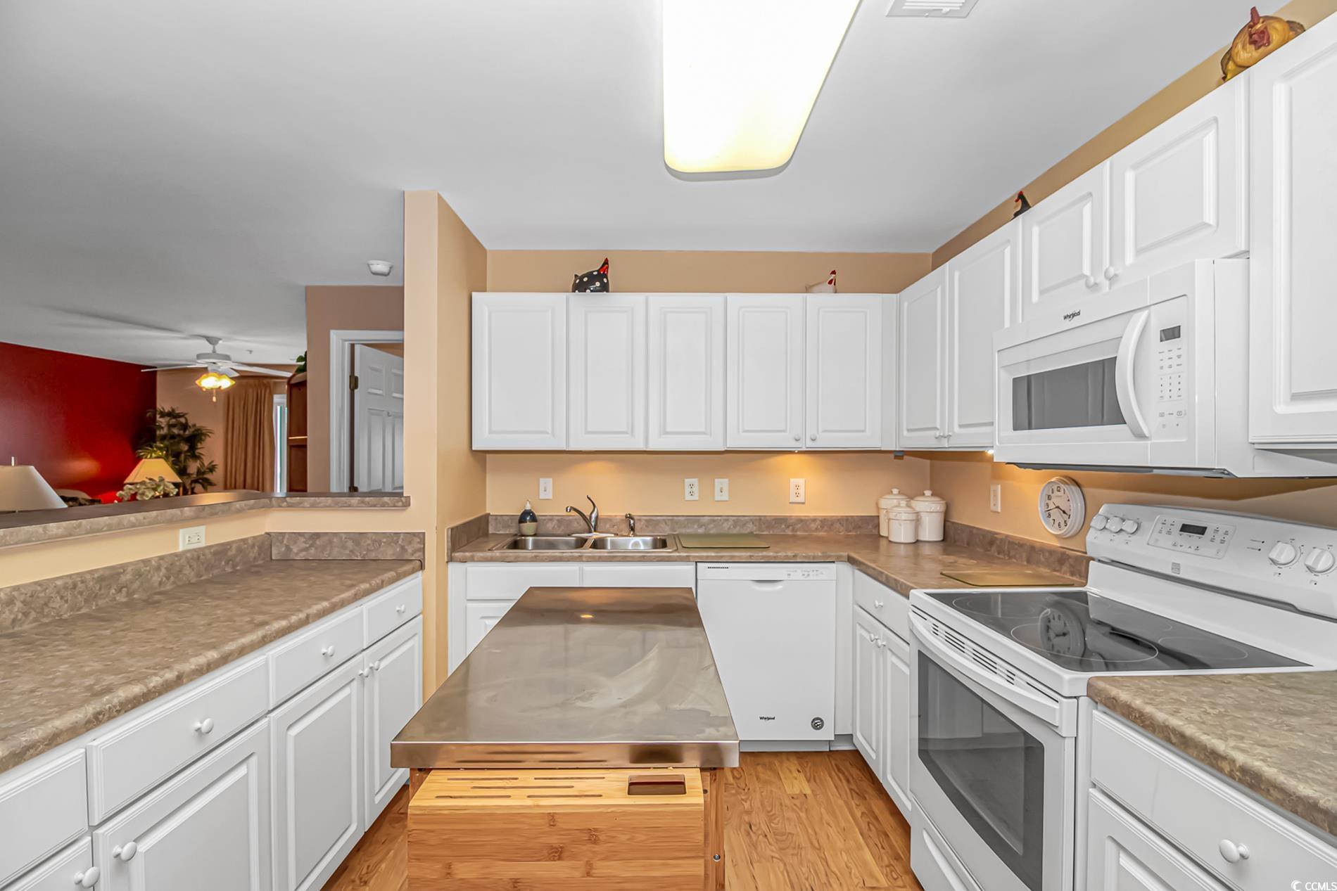 4366 Rivergate Lane, Unit 306 Little River, SC 29566 - Photo 5 of 32 Kitchen featuring white appliances, white cabinets, light wood-style flooring, and ceiling fan