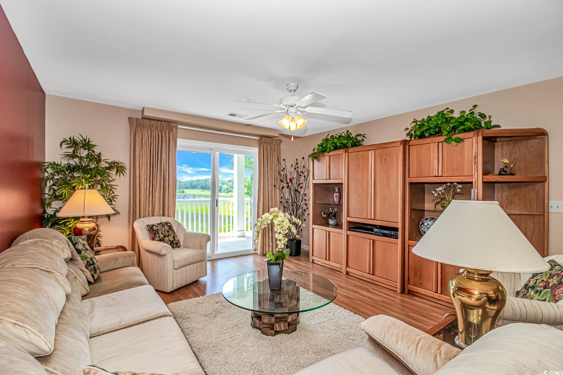 4366 Rivergate Lane, Unit 306 Little River, SC 29566 - Photo 8 of 32 Living room with a ceiling fan and light wood-style flooring