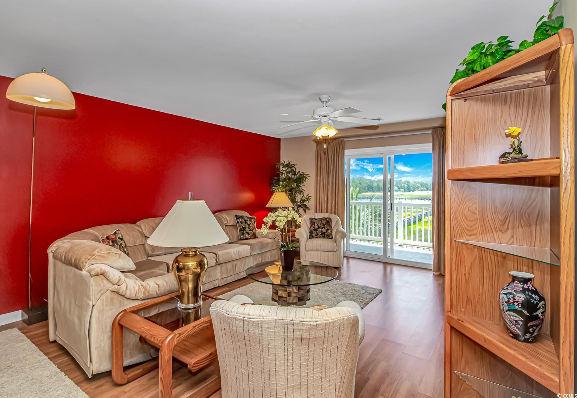 4366 Rivergate Lane, Unit 306 Little River, SC 29566 - Photo 10 of 32 Living room with wood finished floors and a ceiling fan