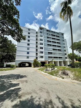a view of a building with a backyard
