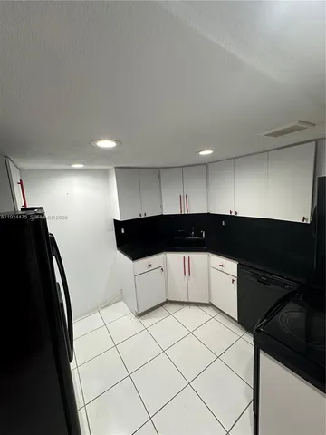 a kitchen with a sink and a refrigerator