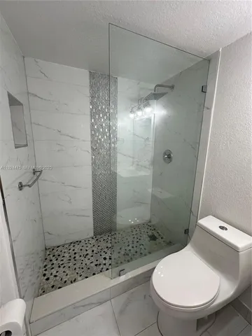 a bathroom with a toilet and shower