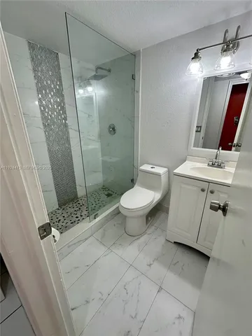 a bathroom with a sink toilet and shower