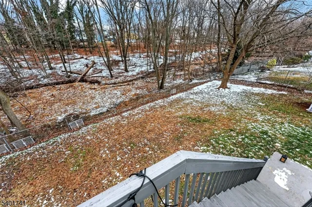 a view of backyard with deck and wooden floor
