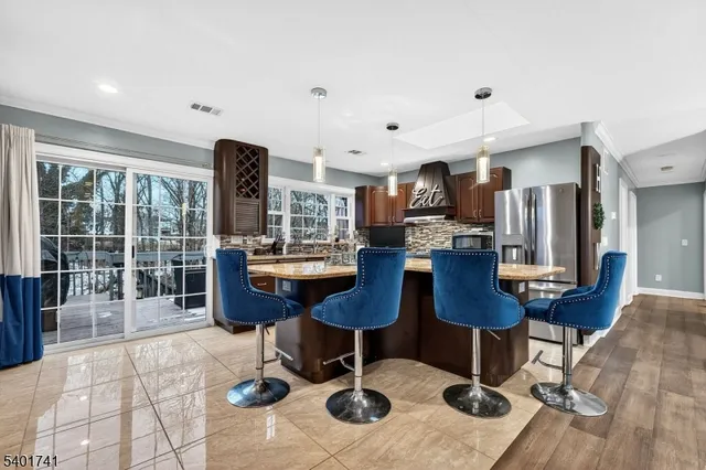 a room with lots of furniture a rug and a chandelier