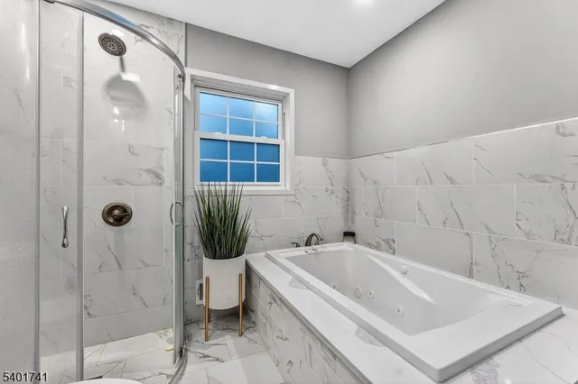 a bathroom with a tub and shower