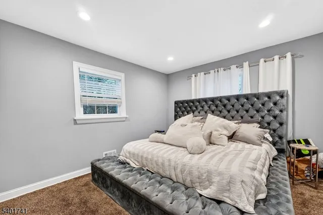 a bedroom with bed and window