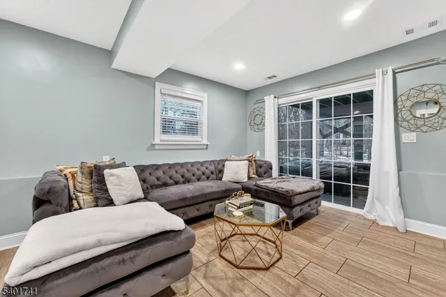 a living room with furniture large window and couch