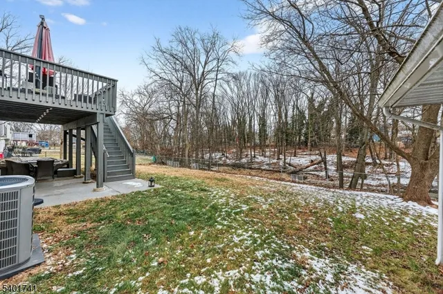 a view of a deck with table and chairs and wooden fence