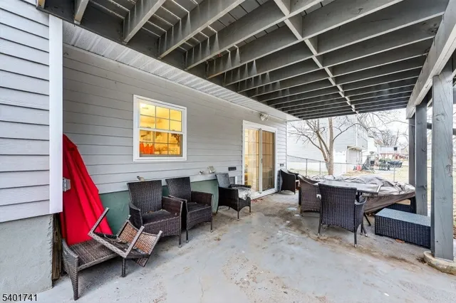 a view of a patio with table and chairs
