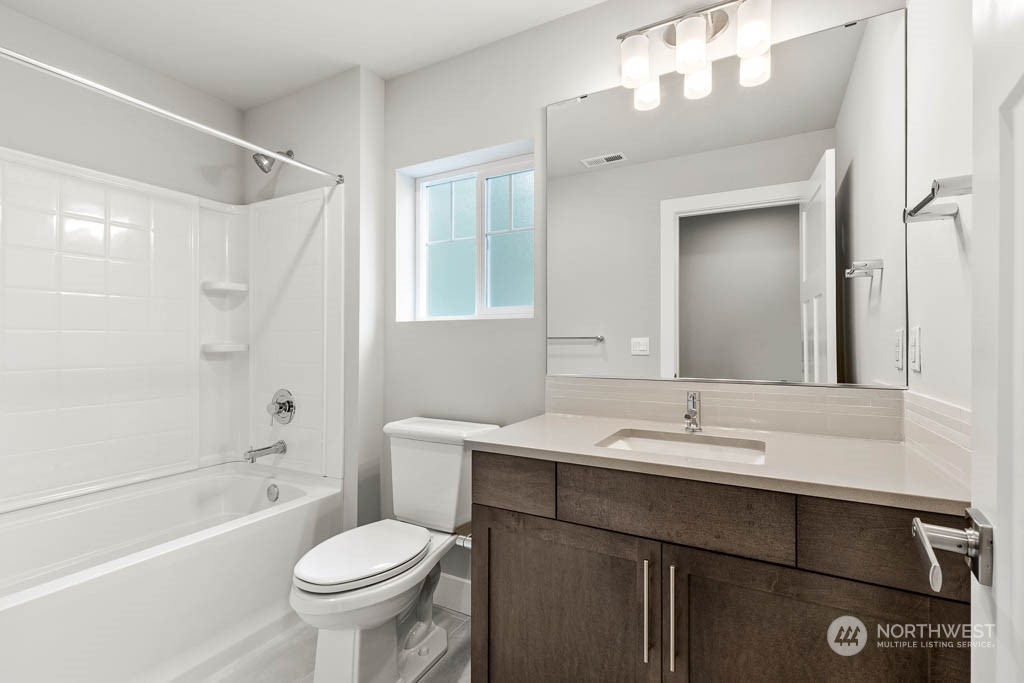 21423 Royal Anne Road, Unit RM1 Bothell, WA 98021 - Photo 13 of 26 a bathroom with a sink toilet a mirror and shower