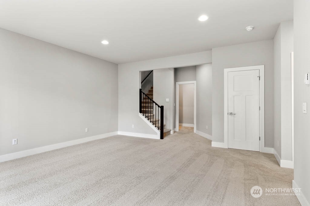 21423 Royal Anne Road, Unit RM1 Bothell, WA 98021 - Photo 15 of 26 an empty room with staircase and a ceiling fan