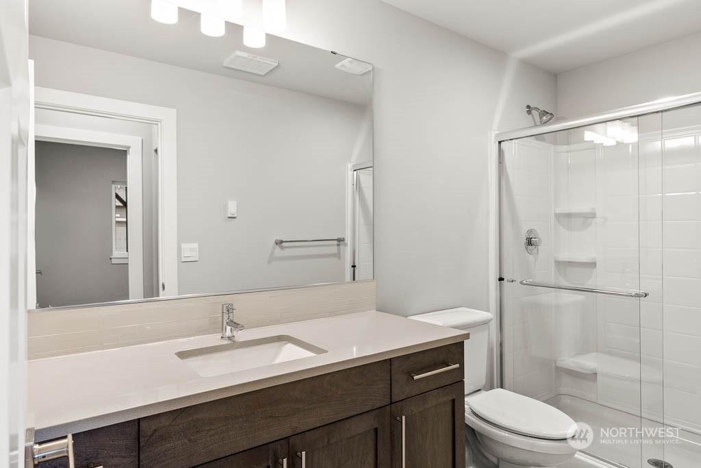 21423 Royal Anne Road, Unit RM1 Bothell, WA 98021 - Photo 18 of 26 a bathroom with a sink a toilet a mirror and shower
