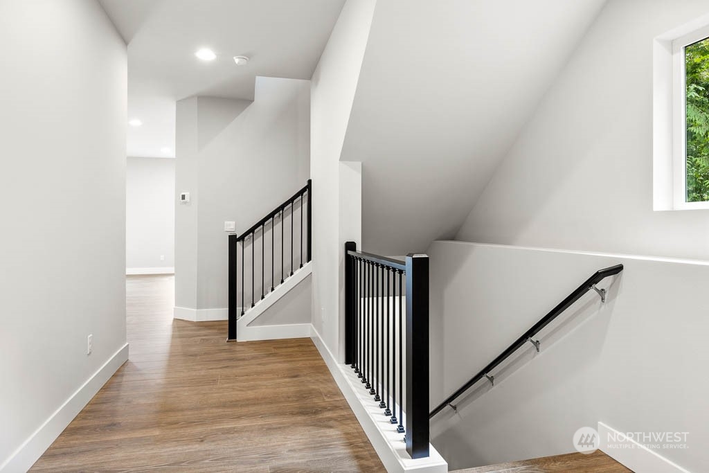 21423 Royal Anne Road, Unit RM1 Bothell, WA 98021 - Photo 21 of 26 a view of a hallway with wooden floor and staircase