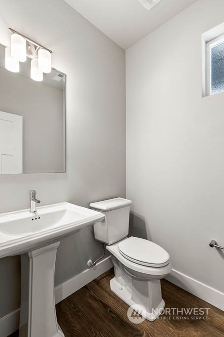 21423 Royal Anne Road, Unit RM1 Bothell, WA 98021 - Photo 22 of 26 a white toilet sitting next to a bathroom sink