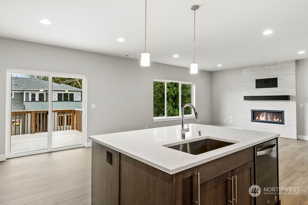 21423 Royal Anne Road, Unit RM1 Bothell, WA 98021 - Photo 26 of 26 a kitchen with a sink a center island and stainless steel appliances
