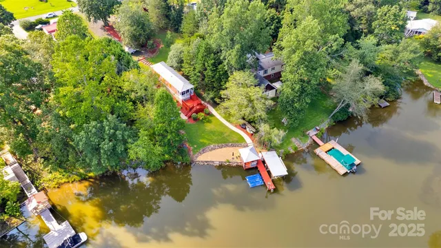 an aerial view of a swimming pool with lounge chair