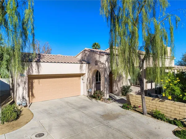 a view of a house with a yard and garage