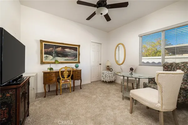 a living room with furniture a rug and a flat screen tv