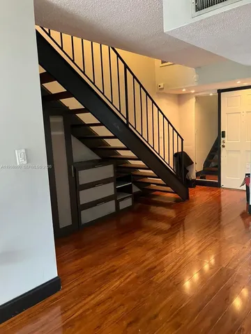 a view of entryway with wooden floor