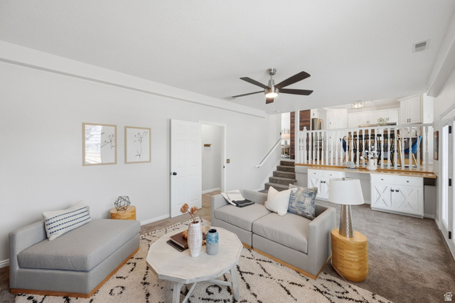 3732 Campbell Road Tooele, UT 84074 - Photo 28 of 69 Open-concept living area featuring a ceiling fan, plush carpet flooring, and a stairway with carpeted treads