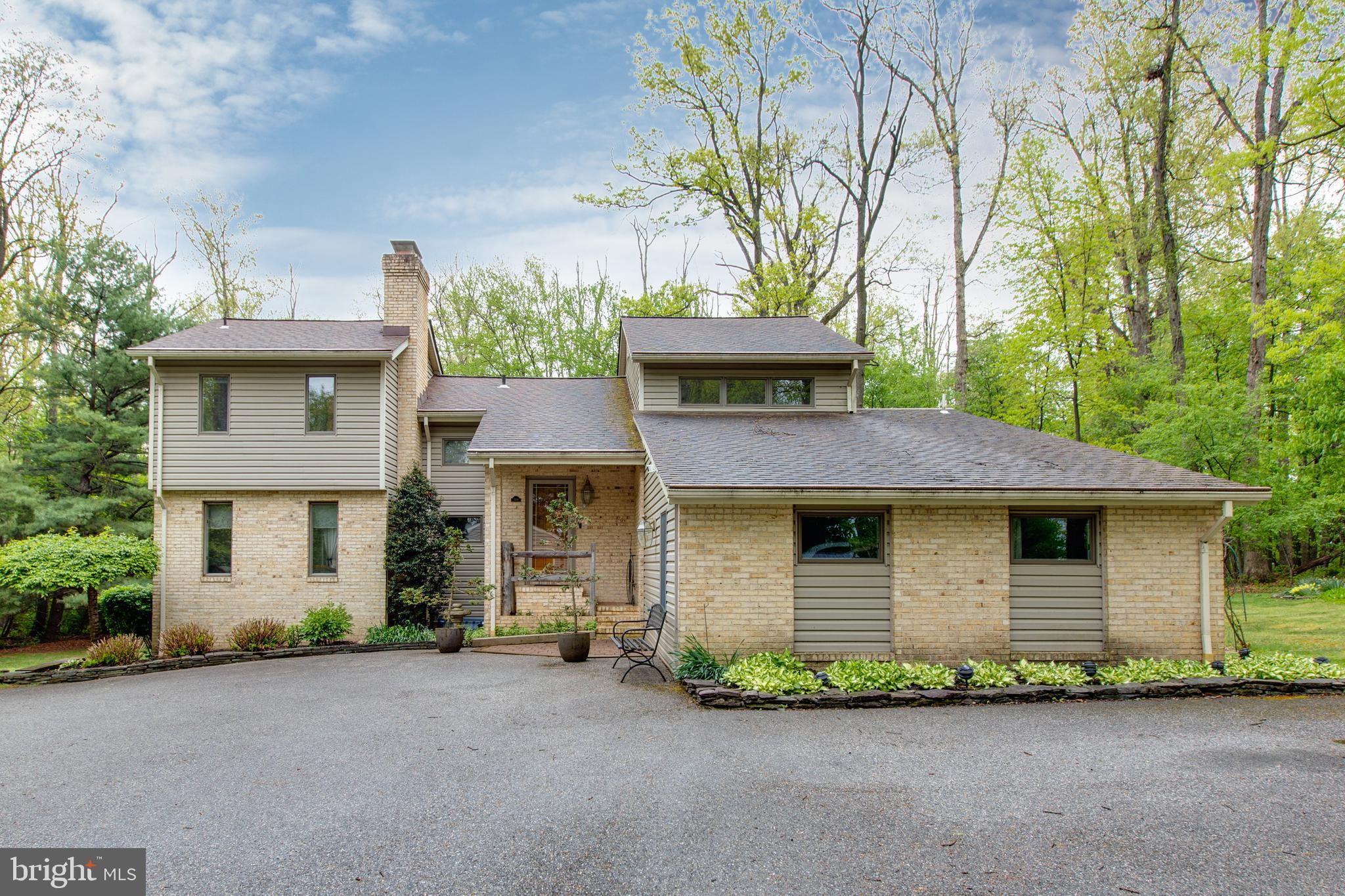 5519 Woodbine Road Sykesville, MD 21784 - Photo 61 of 69 a front view of a house with a garden