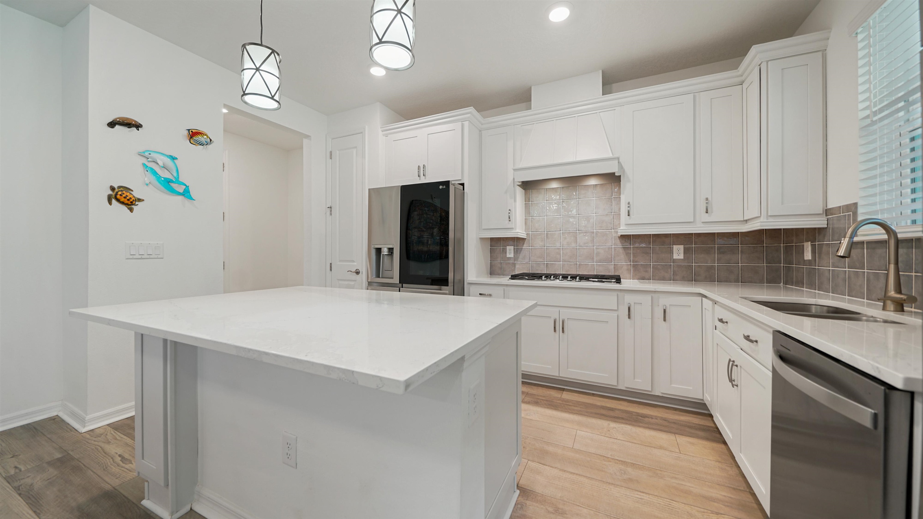 a kitchen with kitchen island granite countertop cabinets and stainless steel appliances