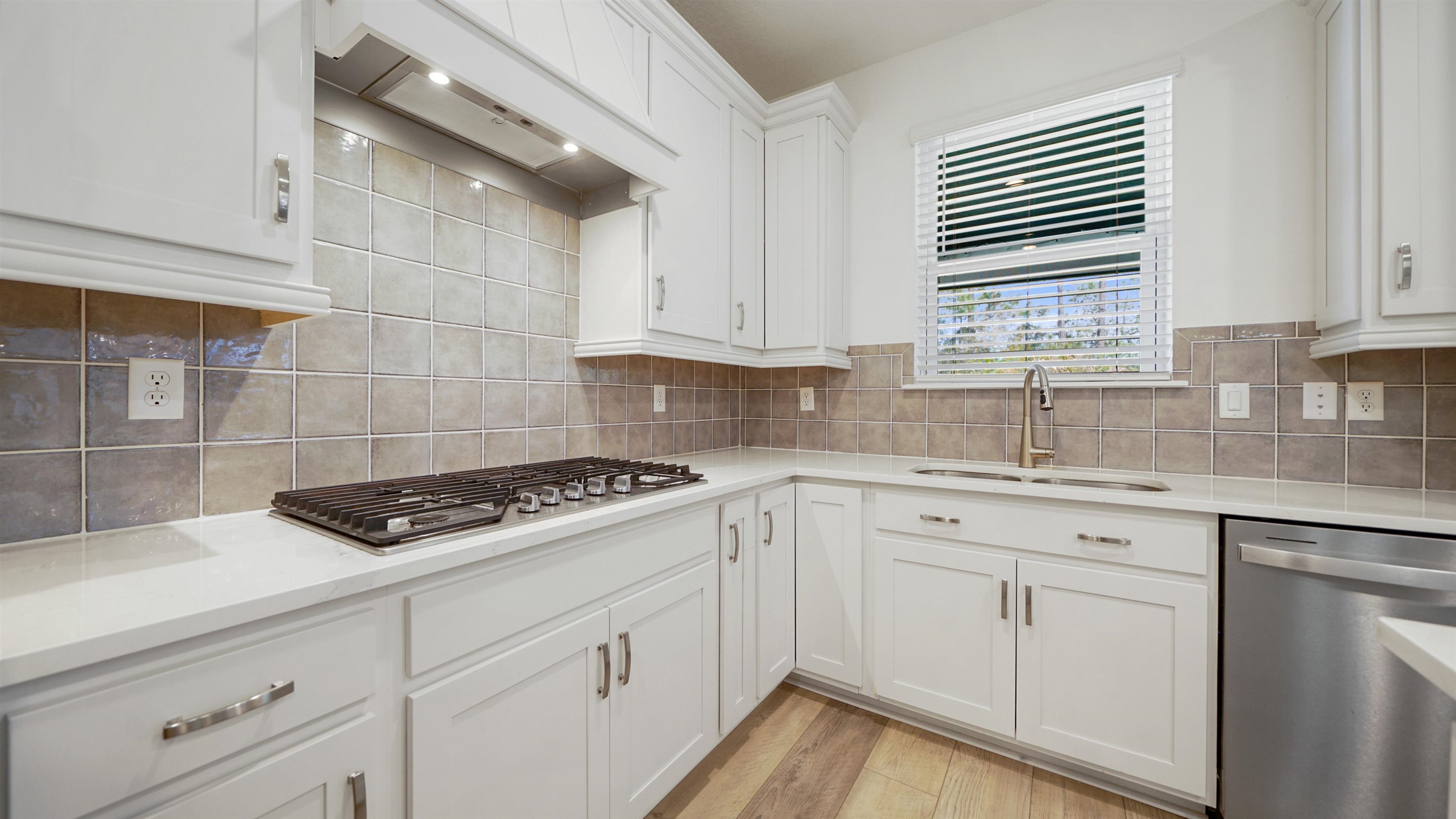 314 Red Barn Road St. Augustine, FL 32092 - Photo 14 of 45 a kitchen with white cabinets a sink stove and dishwasher
