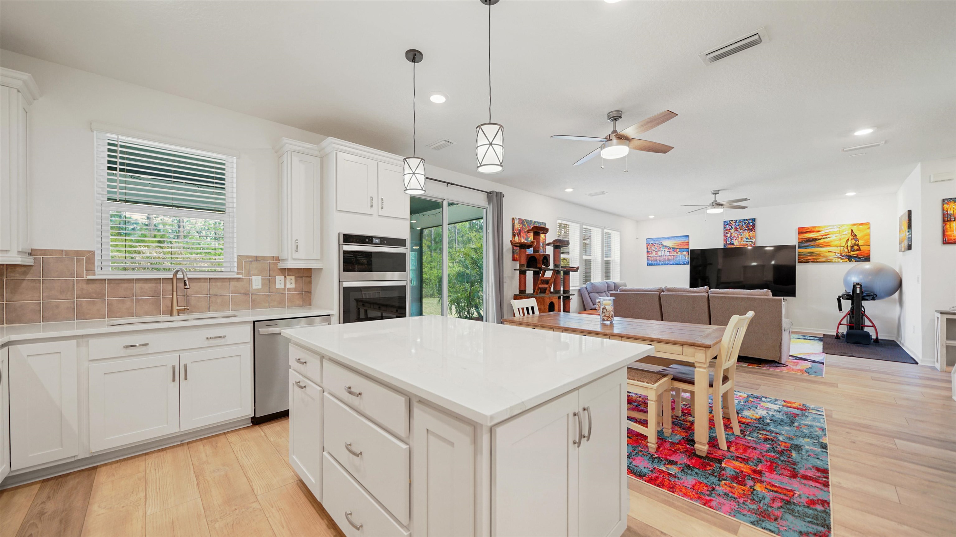314 Red Barn Road St. Augustine, FL 32092 - Photo 15 of 45 a large white kitchen with a large window a oven and stainless steel appliances