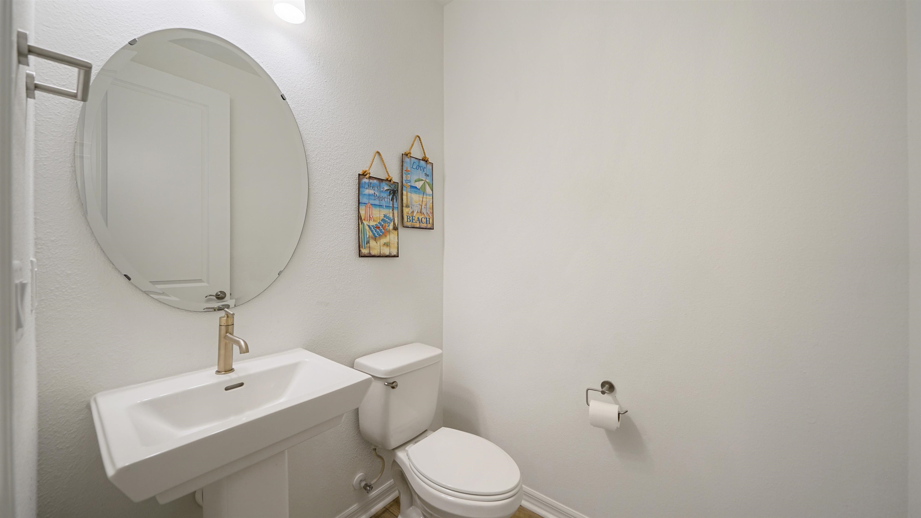 314 Red Barn Road St. Augustine, FL 32092 - Photo 16 of 45 a bathroom with a toilet a sink and mirror