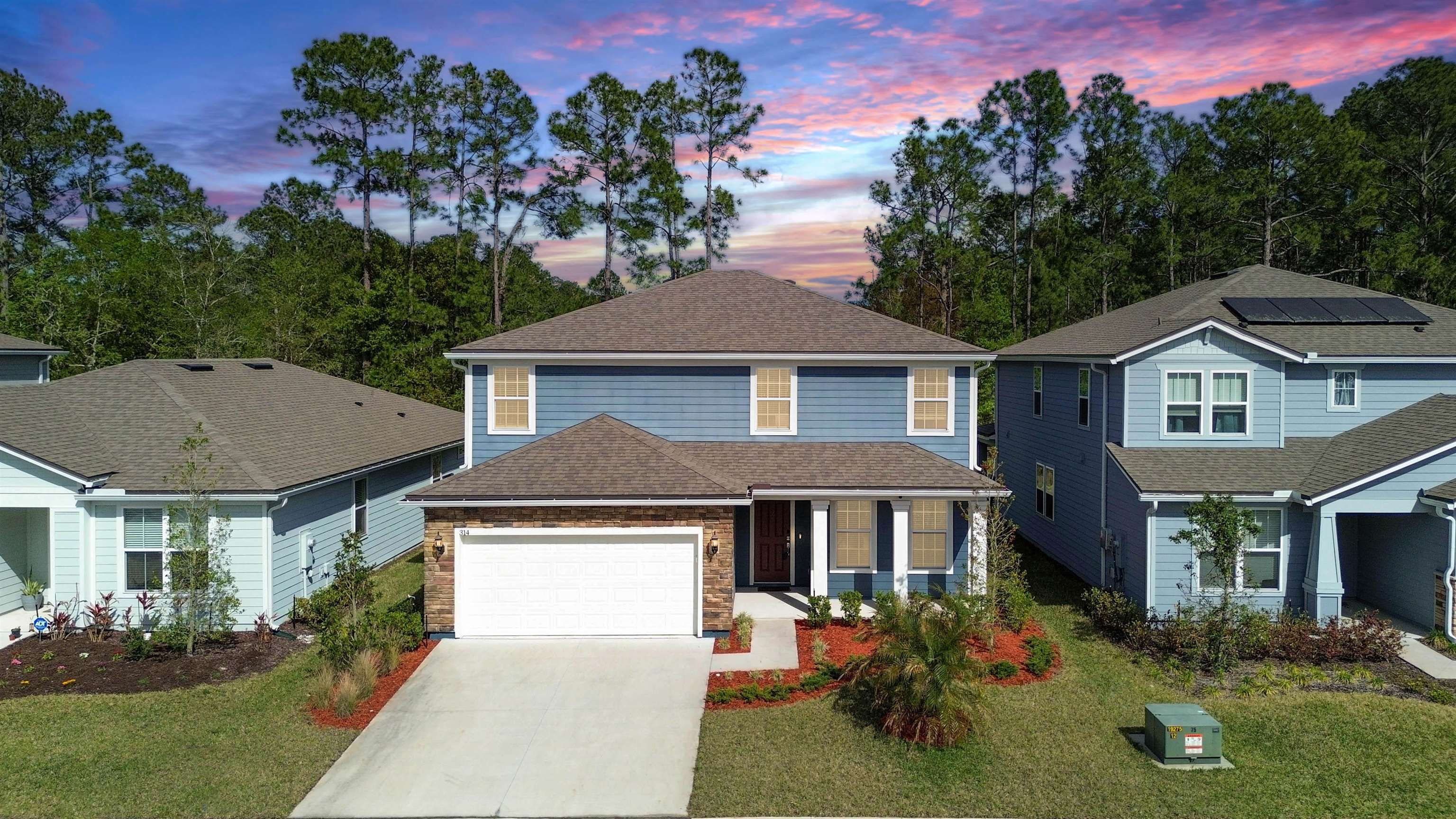 314 Red Barn Road St. Augustine, FL 32092 - Photo 2 of 45 a front view of a house with garden